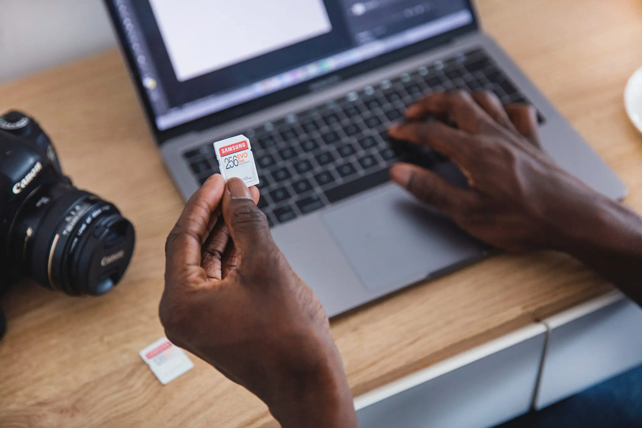 photographer transferring photos from camera for culling